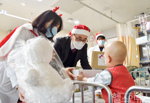 화순전남대병원 직원들과 한국백혈병소아암협회 김봉학 광주전남지회 사무국장(가운데)이 지난 23일 치료받고 있는 소아 환자들을 찾아 성탄 선물을 전달하고 있다. (화순전남대병원 제공)
