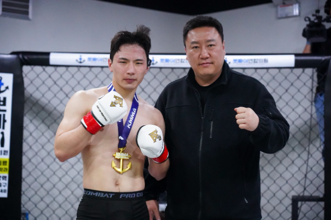 김해율하팀매드 배성국(왼쪽)이 ’뽀빠이연합의원KMMA아산1’ 메인이벤트 승리 후 KMMA충남아산 지역담당 이승룡 위원과 기념 촬영을 하고 있다. 사진=스탠다드앤드프로그레스 스포츠에이전시 제공