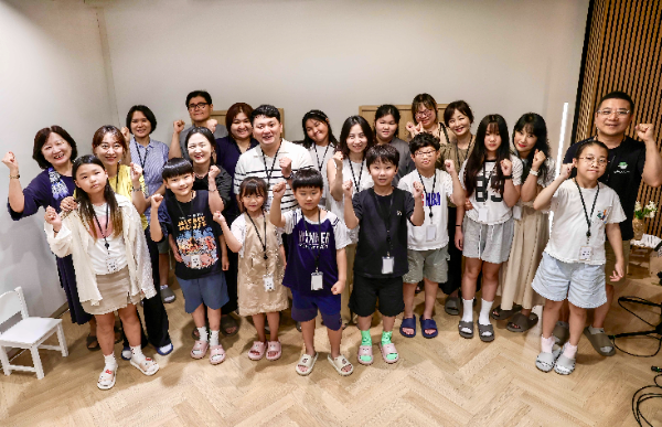 KTis 임직원과 자녀가 함께 동화책 낭독 봉사활동을 위한 단체사진을 촬영하고 있다.
