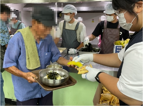 HR그룹 임직원과 쿠팡 배송기사(퀵플렉서)들이 충청북도노인종합복지관 구내식당에서 지역 어르신들을 위해 점심 배식 봉사를 하고 있다./사진=HR그룹㈜ 미디어팀 제공