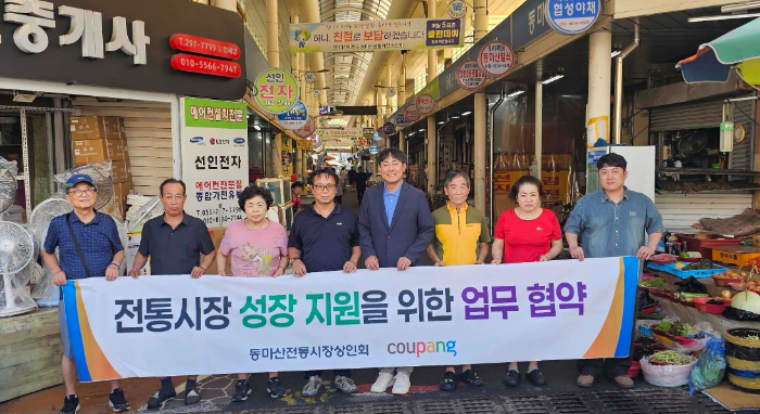윤상수 동마산전통시장상인회장(왼쪽에서 네번째), 김종춘 쿠팡 서비스정책실 상무(왼쪽에서 다섯번째), 시장상인들이 업무 혁약 기념 사진을 촬영하고 있다.