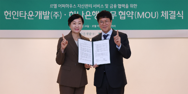 하나은행은 지난 24일, 헌인타운개발㈜과 서울 강남권에 위치한 고급 주거단지 ‘르엘 어퍼하우스’의 입주자 등을 대상으로 자산관리 서비스 및 손님 마케팅 협력을 위한 업무협약(MOU)을 체결했다. 협약식에 참석한 이은정 하나은행 하나더넥스트본부장(사진 왼쪽)이 김용 헌인타운개발(주) 대표와 함께 업무협약서를 들고 기념 촬영을 하고 있다.