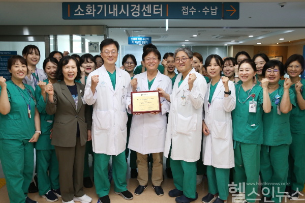 서울아산병원 소화기내시경센터 의료진이 세계내시경협회 최우수 내시경센터 인증패를 들고 기념촬영을 하고 있다. (사진 제공=서울아산병원)