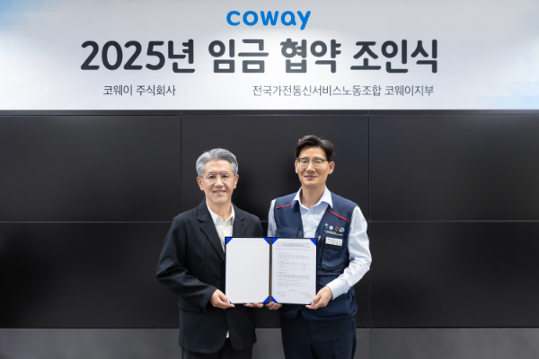 서장원 코웨이 대표이사(왼쪽)와 임창경 코웨이지부 지부장이 '2025년 임금 협약'을 체결한 뒤 기념촬영을 하고 있다.