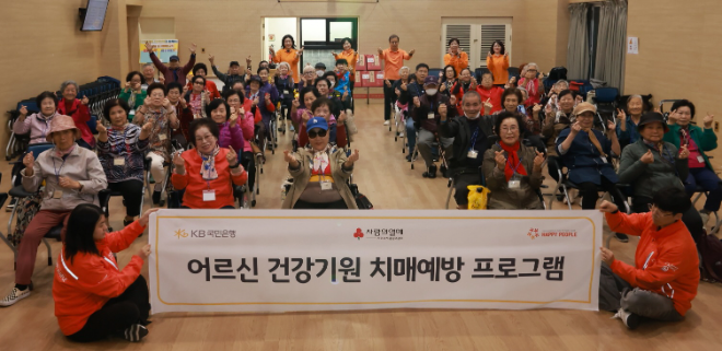 지난 22일 서울 광진구 시립광진노인복지관에서 열린 '어르신 건강기원 치매예방 프로그램'에 참여한 어르신들이 기념촬영을 하고 있다. ⓒ KB국민은행