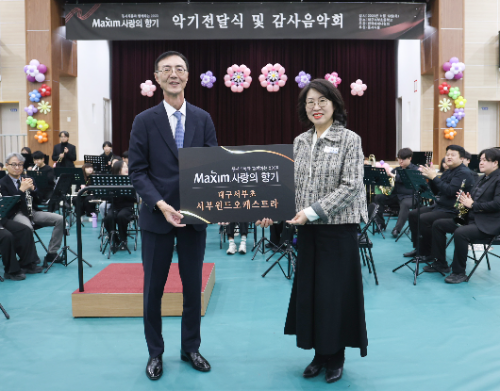 지난 13일 대구서부초등학교에서 열린 ‘제18회 맥심 사랑의 향기’ 행사에서 최상인 동서식품 홍보상무(왼쪽)와 이보경 대구서부초등학교 교장(오른쪽)이 기념촬영을 하고 있다. / 사진 = 동서식품