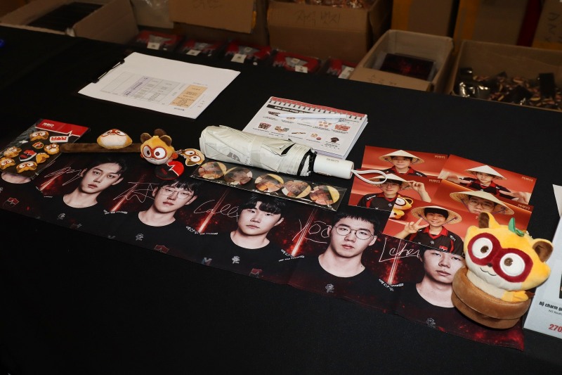Goods (products) displayed at the site. Photo cards of players wearing traditional Vietnamese hats were popular.