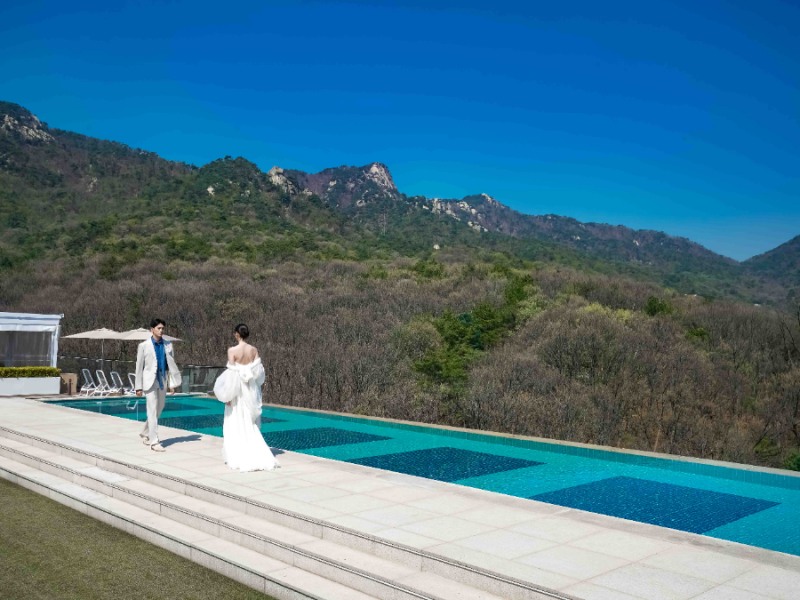 안토 인피니티풀에서 서로 마주 보고 있는 신랑과 신부