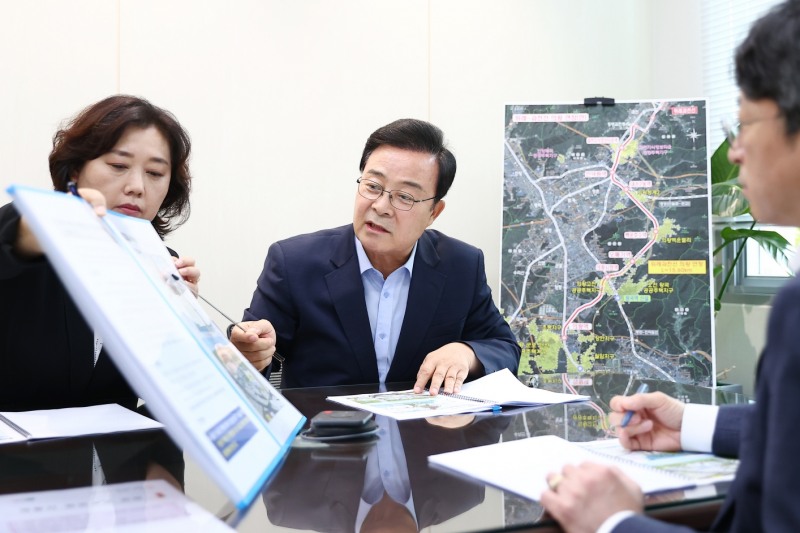 김성제 의왕시장이 홍지선 국토교통부 2차관에게 핵심 철도사업을 설명하고 있다. /의왕시