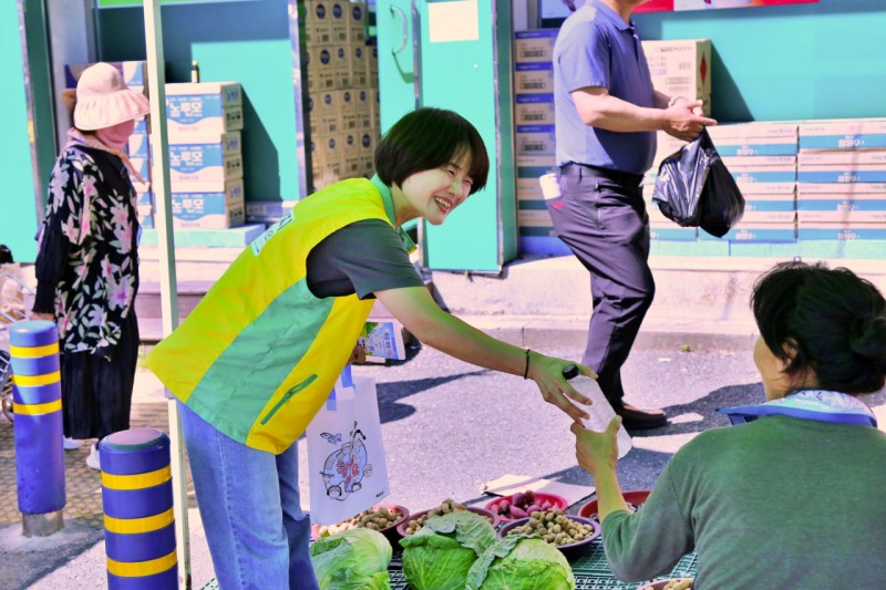 지난 12일 신천지자원봉사단 순천지부 봉사자가 순천시 아랫장에서 상인에게 생수와 온열질환 예방 물품을 나눠 주고 있다. / 사진 제공: 신천지자원봉사단