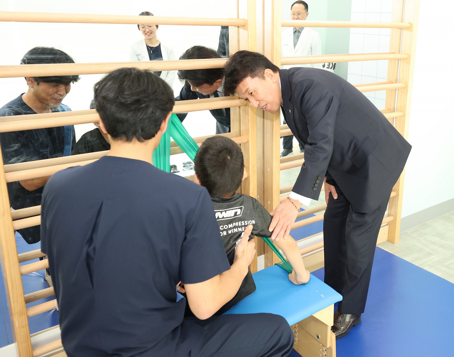 하나금융그룹은 장애인의 건강한 성장과 경제적 자립을 위한 생애주기별 맞춤형 통합 지원 사업을 실시한다고 밝혔다. 이번 사업의 첫 시작으로 지난 17일 서울 마포구 소재 푸르메재단 넥슨어린이재활병원에서 ‘장애 아동ㆍ청소년을 위한 재활 및 학습 보조기구 전달식’을 가졌다. 이날 전달식에 참석한 함영주 회장(사진 맨 오른쪽)이 중추신경계 발달치료를 받고 있는 장애 아동에게 따뜻한 격려의 말을 전하고 있다.