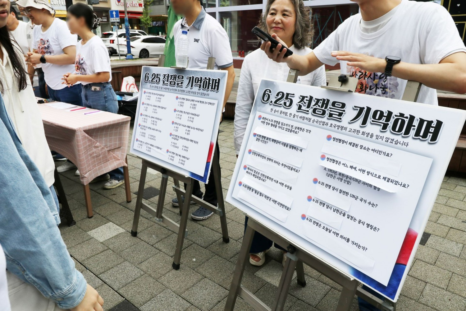 신천지자원봉사단 김포지부가 지난 19일 오전 장기역 시계탑광장에서 '호국보훈 캠페인'을 진행한 가운데 자원봉사자들이 시민들과 함께 퀴즈를 풀고 있다. (사진 제공: 신천지자원봉사단 김포지부)